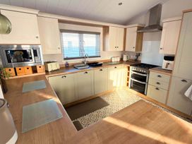 A kitchen equipped with a stove, sink, and microwave at the property