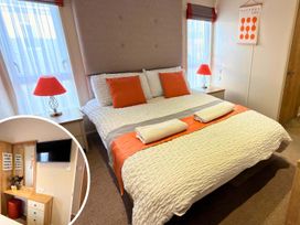 A bedroom with a bed and bedside lamp at The Old Barn in Manchester