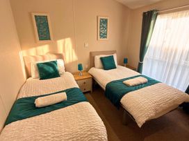 A bedroom with twin beds and a bedside table at The Old Barn in Manchester