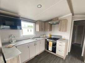A kitchen with a stove and cabinets at the property in Builth Wells