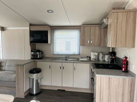 A kitchen with appliances and cabinetry at the property in Builth Wells