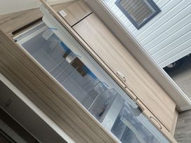 A refrigerator with a freezer compartment in a kitchen at 