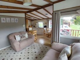 A living room with a sofa and dining area at The Old Barn in Builth Wells
