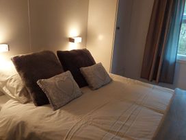 A bedroom with a bed and decorative pillows at Builth Wells