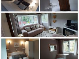 A living room with a sofa and television at The Old Barn in Builth Wells