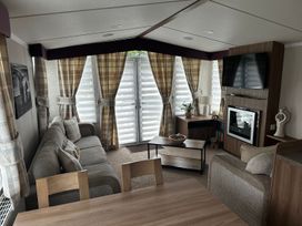 A living room with a sofa and television at a beach house