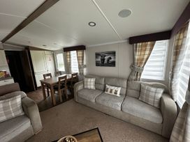 A living room with a sofa and dining table at The Old Barn in Manchester