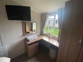 A bedroom with a desk and mirror at the property in location