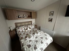 A bedroom with a bed and bedside tables at The Old Barn in Manchester