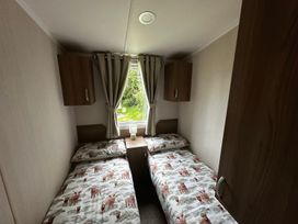 A bedroom with two beds and a window at a property
