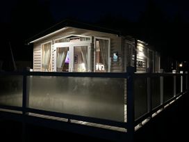 A house with lit windows and a deck at a vacation property