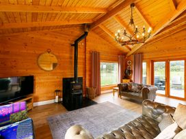 A living room with a fireplace and a television at the property in location