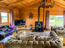 A living room with a sofa and wood stove at The Old Barn in Manchester