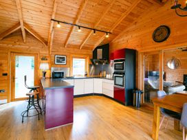 A kitchen with bar stools and modern appliances at the property location