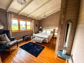 A bedroom with a bed and chair at The Old Barn in Manchester