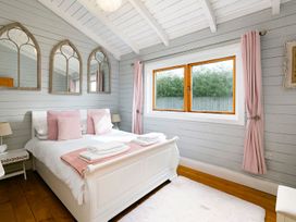 A bedroom with a bed and mirrors at 