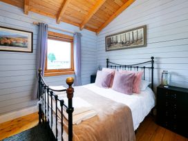 A bedroom with a bed and nightstand at The Old Barn in Manchester