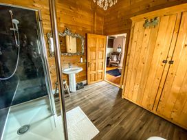 A bathroom with a shower, sink, and mirror at the property