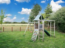 A playground with a slide and swing set in a grassy area