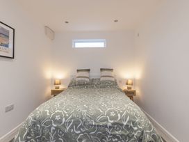 A bedroom with a bed and nightstands at 1Bed Coastal Retreat Sleeps 2 Parking Wifi Bude