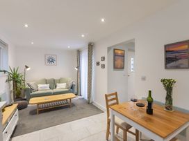 A living room with a sofa and dining table at 1Bed Coastal Retreat Sleeps 2 Parking Wifi, Bude