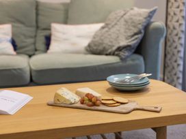 A living room with cheese and grapes on a table at 1Bed Coastal Retreat Sleeps 2 Parking Wifi in Bude