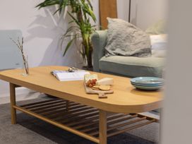 A coffee table with snacks and a plant in a living room at 1Bed Coastal Retreat Sleeps 2 Parking Wifi Bude