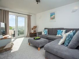 A living room with a sofa and television at Spacious 3 Bed House Sleeps 6 Parking Wifi in Newquay