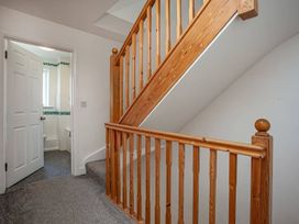 A staircase and doorway in a hallway at Spacious 3 Bed House Sleeps 6 Parking Wifi Newquay