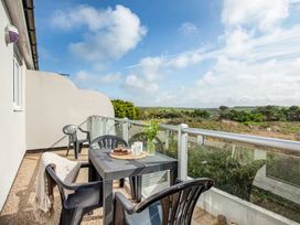 A balcony with a table and chairs at Spacious 3 Bed House Sleeps 6 Parking Wifi in Newquay