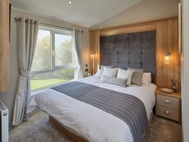 A bedroom with a bed and window at 2Br Lodge Pool Fireplace PetsOK Parking in Goonhavern