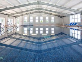 An indoor pool with seating area at 2Br Lodge Pool Fireplace PetsOK Parking in Goonhavern