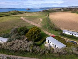 An aerial view of houses and fields near the sea at Coastal Hideaway in Cornwall Dog Friendly, Goldsithney
