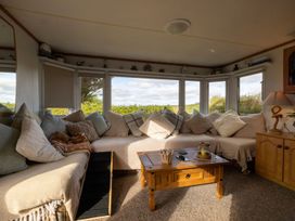 A snug with sofa and coffee table at Coastal Hideaway in Cornwall Dog Friendly Goldsithney