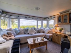 A snug with a sofa and coffee table at Coastal Hideaway in Cornwall Dog Friendly, Goldsithney