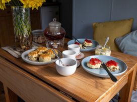 Scones with jam and cream on plates at Coastal Hideaway in Cornwall Dog Friendly, Goldsithney