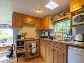 A kitchen with cabinets and a stove at Coastal Hideaway in Cornwall Dog Friendly Goldsithney