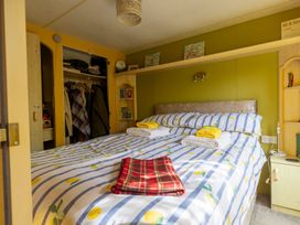 A bedroom with a bed and wardrobe at Coastal Hideaway in Cornwall Dog Friendly Goldsithney