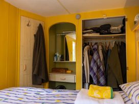 A bedroom with a wardrobe and bed at Coastal Hideaway in Cornwall Dog Friendly Goldsithney