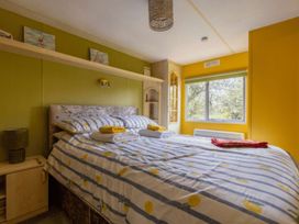 A bedroom with a bed and window at Coastal Hideaway in Cornwall Dog Friendly, Goldsithney