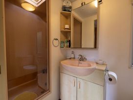 A bathroom with a shower and sink at Coastal Hideaway in Cornwall Dog Friendly Goldsithney