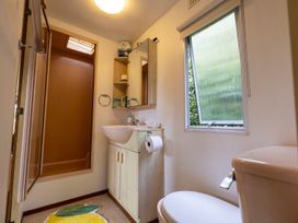 A bathroom with a shower, sink, and toilet at Coastal Hideaway in Cornwall Dog Friendly, Goldsithney