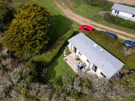 An outdoor view of a house with a patio and cars at Coastal Hideaway in Cornwall Dog Friendly Goldsithney
