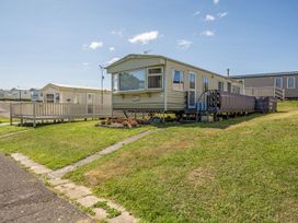 A mobile home with a deck and pathway at 3 Bed Sleeps 8 Sea View Pets Parking Reighton Gap near Filey