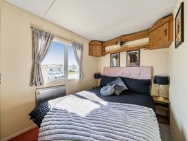 A bedroom with a bed and window at 3 Bed Sleeps 8 Sea View Pets Parking Reighton Gap near Filey