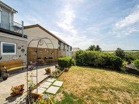 A garden with flower pots and a decorative arch at Studio Sleeps 2 with Parking and Garden Trewidland near Liskeard