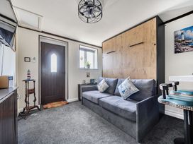 A living room with a door and a sofa at Studio Sleeps 2 with Parking and Garden Trewidland near Liskeard
