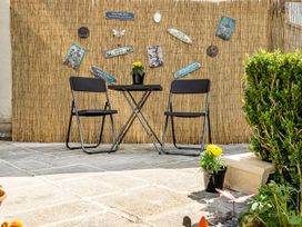 A table and two chairs in an outdoor area at Studio Sleeps 2 with Parking and Garden Trewidland near Liskeard
