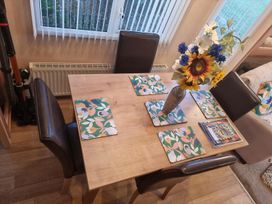 A dining room with a table and chairs at Chalet Sleeps 6 swimming pool Thorness Bay