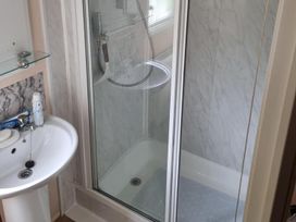 A bathroom with a shower and sink at Chalet Sleeps 6 swimming pool Thorness Bay